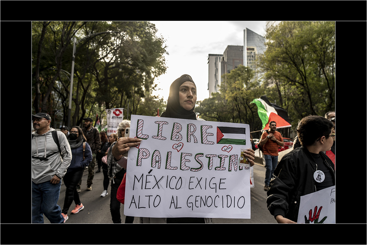 asistentes a la marcha sostienen pancartas que exigen un alto al genocidio en contra del pueblo palestino. Foto Duilio Rodríguez